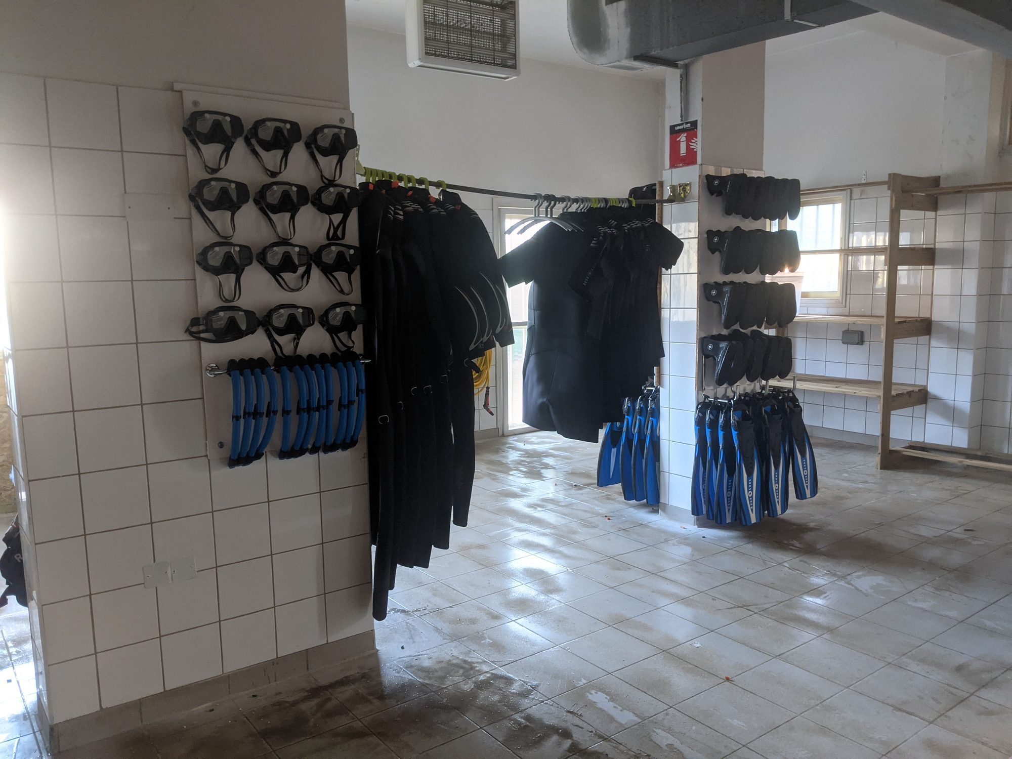 Organized dive equipment kit room at Get Wet Divers